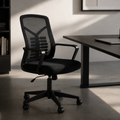 ARTIC black mid-back mesh ergonomic office chair beside dark desk in minimalist home office